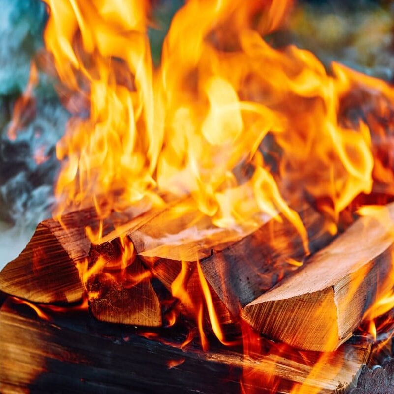 Fire burning in a fire pit. Warm and cozy outdoor setting.